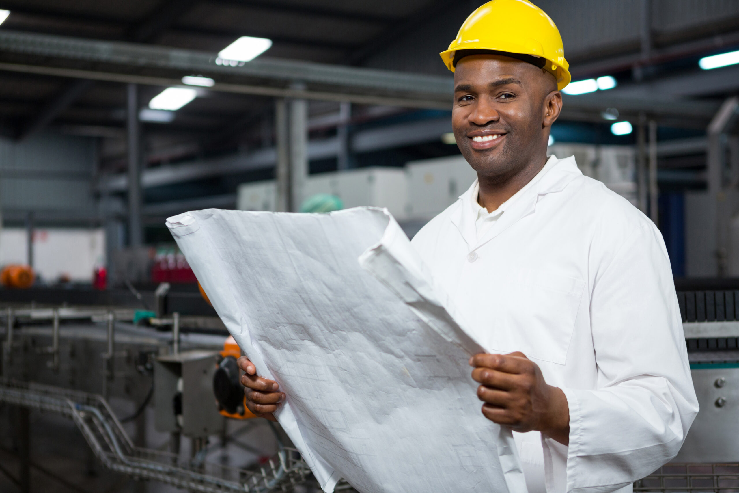 smiling male worker reading instructions juice factory scaled